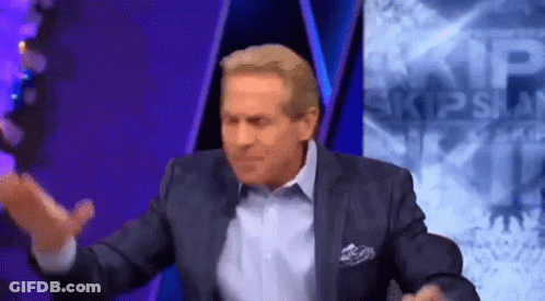Man In Suit Sitting In Front Of Skip Span Sign GIF