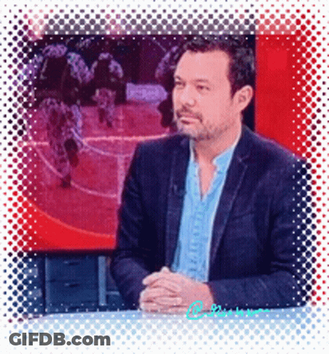 Man In Suit Sitting In Front Of Soldiers Screen GIF