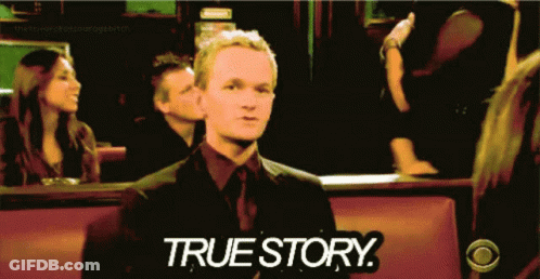 Man In Suit Sitting In Front Of True Story Sign GIF