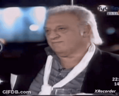 Man In Suit Sitting In Front Of TV Saying Xrecorder GIF