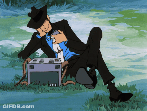 Man In Suit Sitting In Grass With Toaster GIF