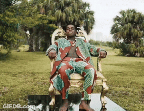 Man In Suit Sitting In Park Chair GIF