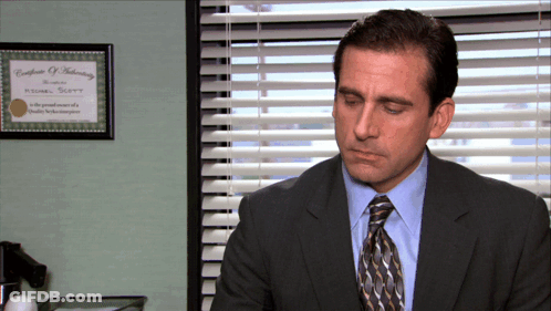 Man In Suit Sitting Near Window GIF