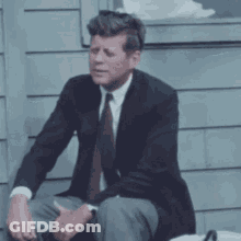 Man In Suit Sitting On Bench GIF