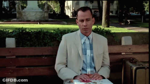 Man In Suit Sitting On Bench With Book GIF