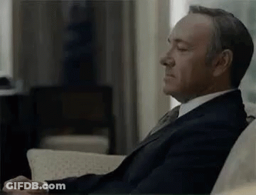 Man In Suit Sitting On Couch GIF