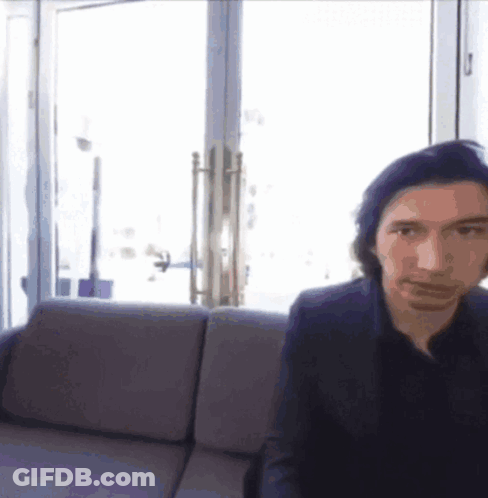 Man In Suit Sitting On Couch By Window GIF