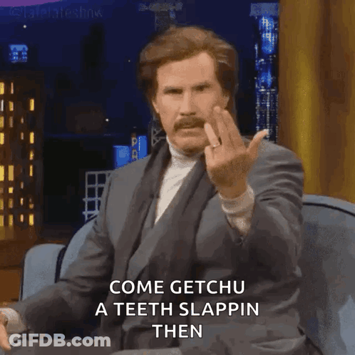 Man In Suit Sitting On Couch Giving Middle Finger GIF