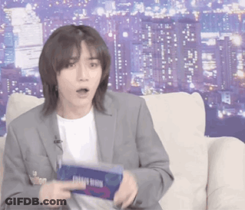 Man In Suit Sitting On Couch Holding Bingo Box GIF