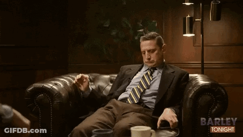 Man In Suit Sitting On Couch Saying Barley Tonight GIF