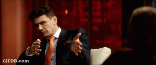 Man In Suit Sitting On Couch GIF