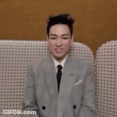 Man In Suit Sitting On Couch With Eyes Closed GIF