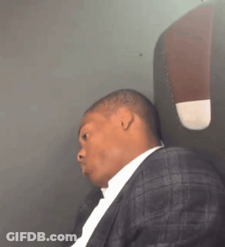 Man In Suit Sitting On Plane GIF