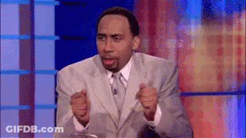 Man In Suit Sitting On Stage GIF