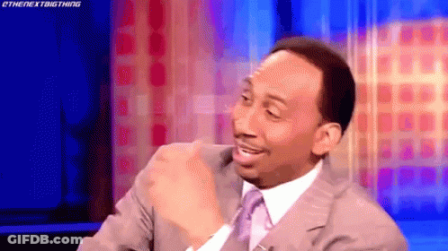 Man In Suit Sitting On Stage GIF