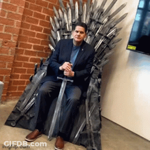 Man In Suit Sitting On Throne With Sword GIF