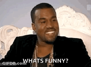 Man In Suit Sitting On White Chair Asking What's Funny GIF