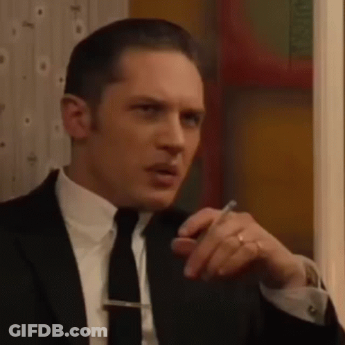 Man In Suit Sitting Saying Very Good GIF