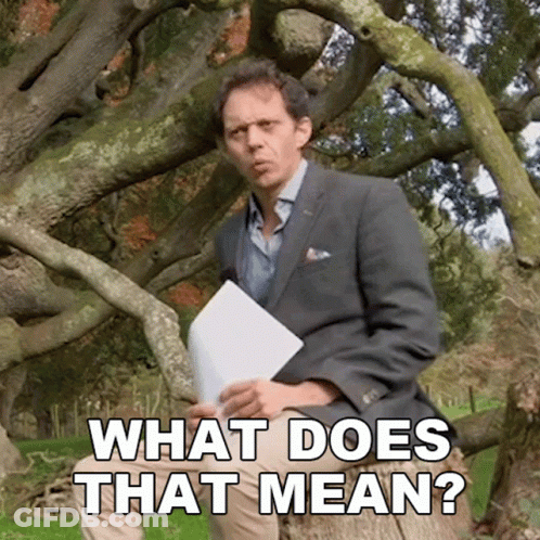 Man In Suit Sitting Under Tree Holding Paper Saying What Does That Mean GIF