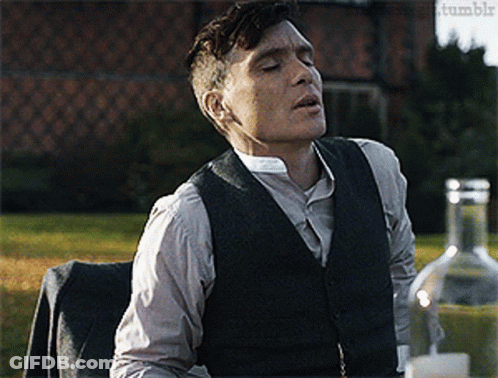 Man In Suit Sitting With Alcohol Bottle GIF