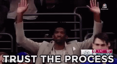 Man In Suit Sitting With Arms Up Trust The Process GIF