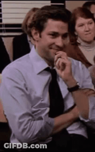 Man In Suit Sitting With Chin On Hand GIF