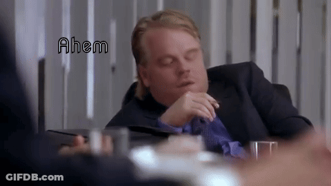 Man In Suit Sitting With Eyes Closed Saying Ahem GIF
