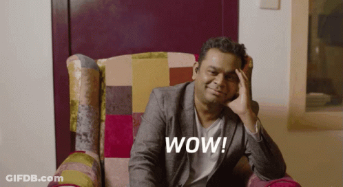 Man In Suit Sitting With Hand On Forehead Wow GIF