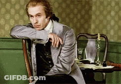 Man In Suit Sitting With Hand On Shoulder GIF