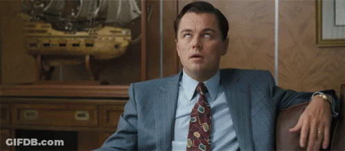 Man In Suit Sitting With Hands On Hips GIF