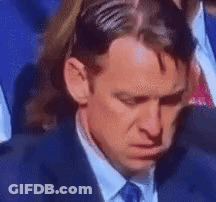 Man In Suit Sitting With Head In Hands GIF