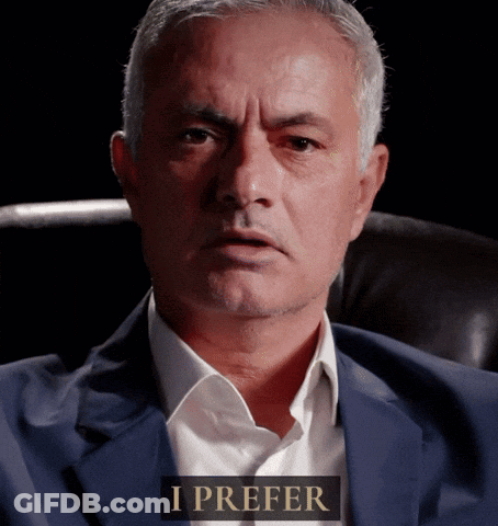 Man In Suit Sitting With I Prefer Sign GIF