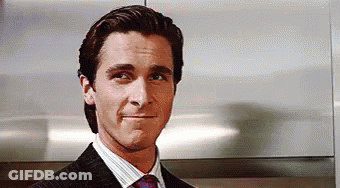 Man In Suit Smiling And Making A Face GIF