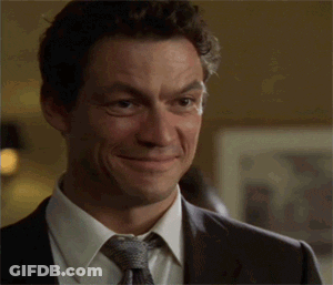 Man In Suit Smiling And Making Funny Face GIF
