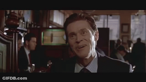 Man In Suit Smiling At Bar GIF