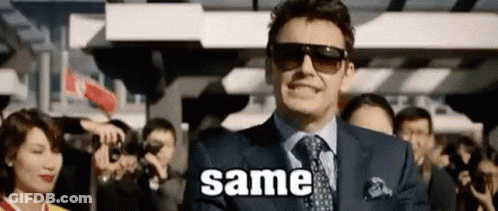 Man In Suit Smiling At Crowd With Sunglasses GIF