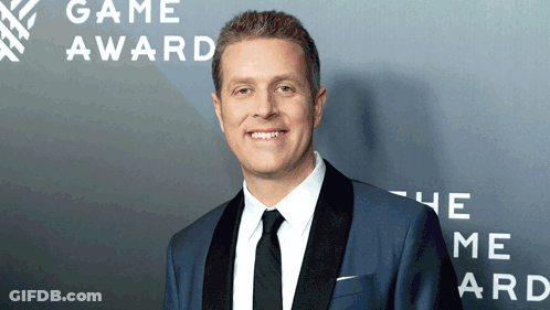 Man In Suit Smiling At Game Award GIF
