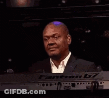 Man In Suit Smiling At Keyboard GIF