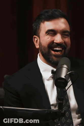 Man In Suit Smiling At Microphone GIF