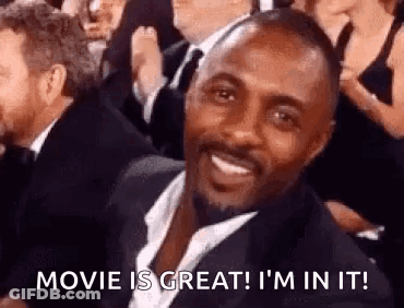 Man In Suit Smiling At Movie Premiere GIF