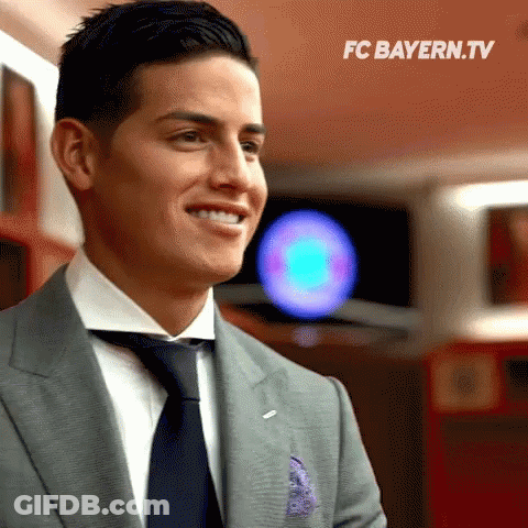Man In Suit Smiling FC Bayern.tv Logo GIF