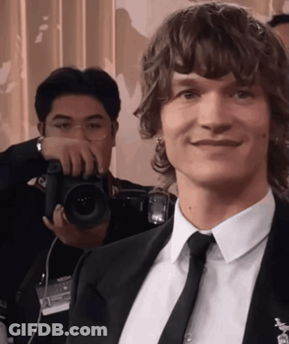 Man In Suit Smiling For Photo GIF