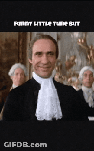 Man In Suit Smiling Funny Little Tune GIF