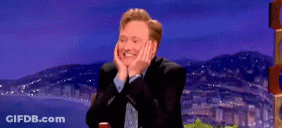 Man In Suit Smiling Hands On Face GIF
