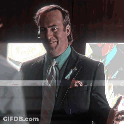Man In Suit Smiling Holding Phone GIF