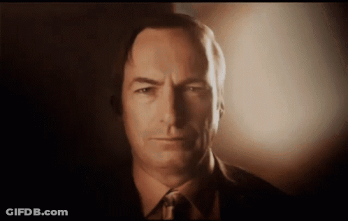 Man In Suit Smiling Holding Phone GIF