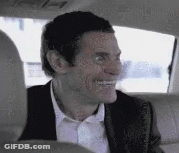 Man In Suit Smiling In Back Seat Of Car GIF