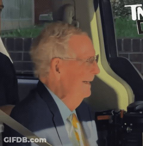 Man In Suit Smiling In Back Seat Of Car GIF