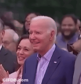 Man In Suit Smiling In Crowd GIF