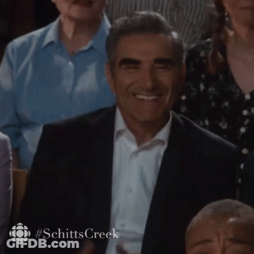 Man In Suit Smiling In Crowd GIF